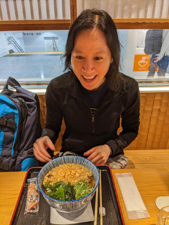 Van sits in a noodle restaurant with a bowl of soba noodles