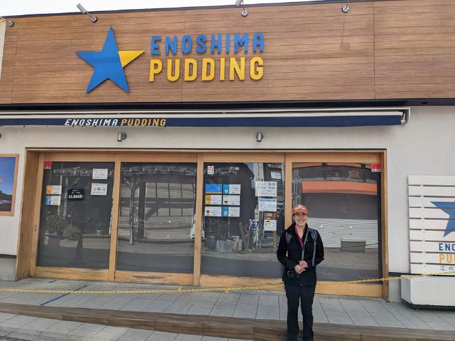 I stand in front of a storefront called Enoshima Pudding