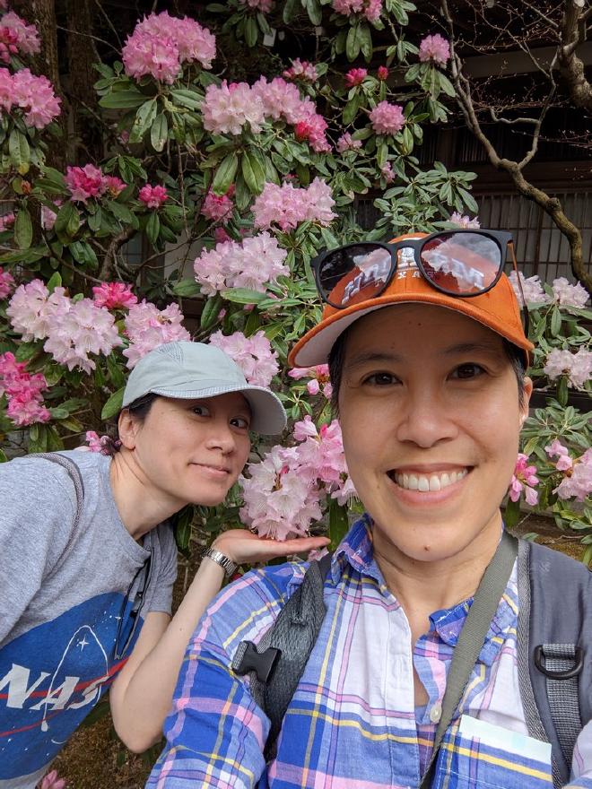 Van and I stand in front of pink rhodedendrons