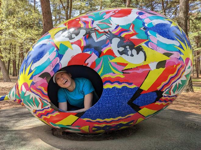 Van peeks out from inside of a giant egg sculpture