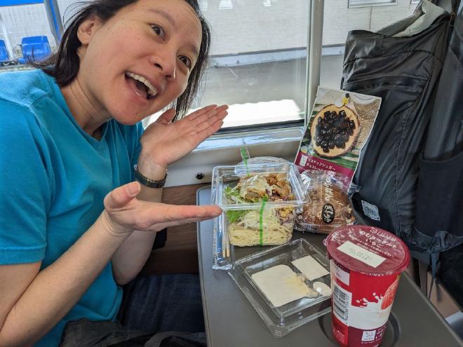 Conbini food on the pull-out table of a bullet train seat