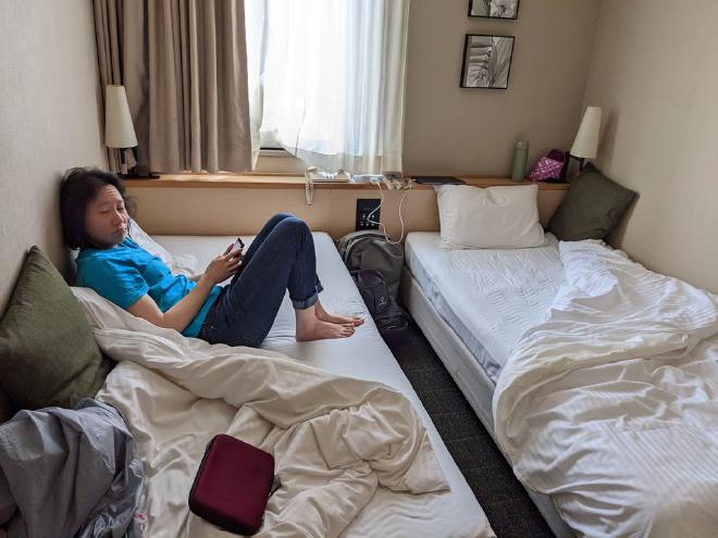 Van lounges on her bed at the hotel waiting for me to get ready to leave the hotel.