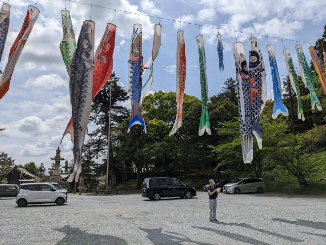 Giant carp streamers float over the shrine parking lot.