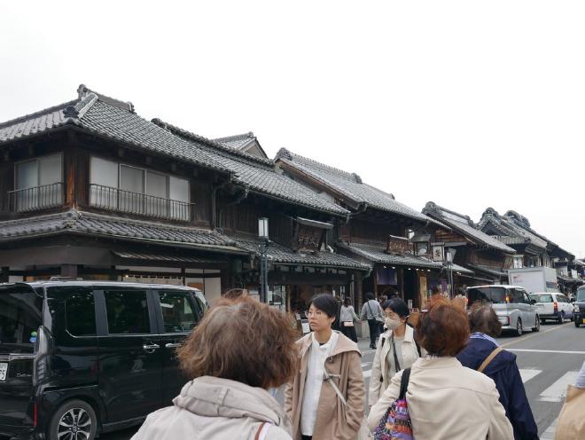 Historic Japanese-style buildings line a busy street in Kawagoe